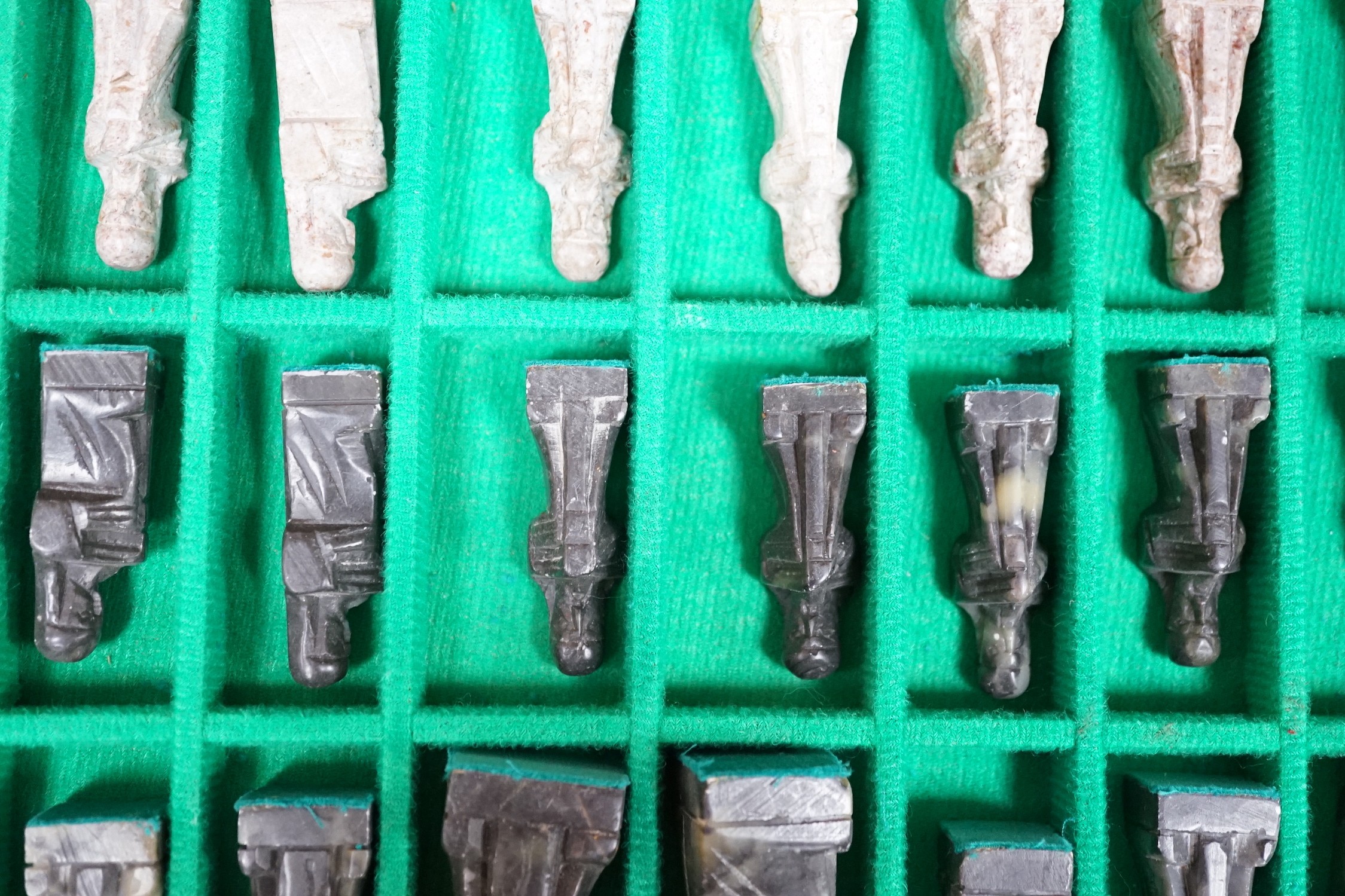 A chess board, with carved soapstone chess pieces